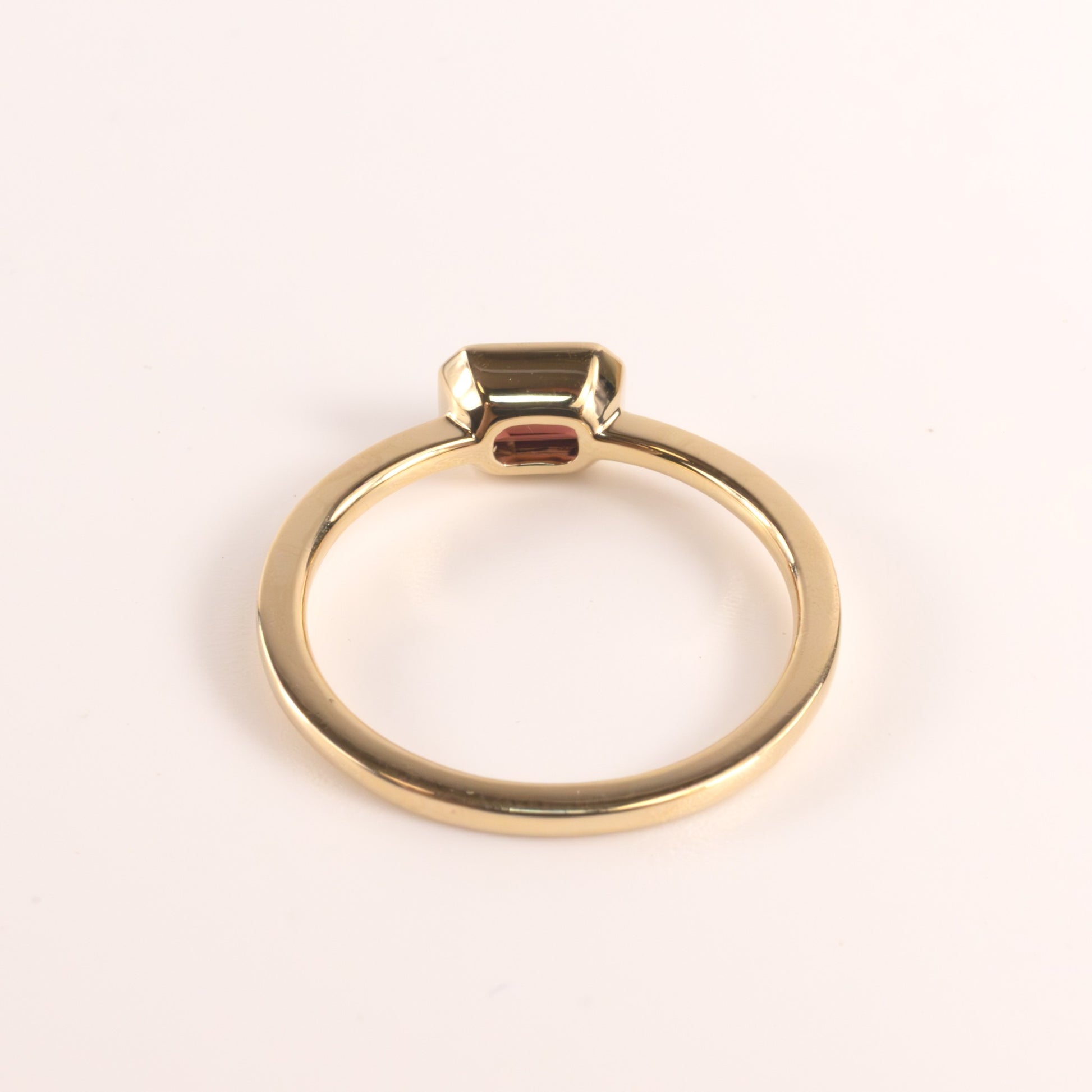 14KYG Garnet Emerald Cut East-West Bezel Set Ring