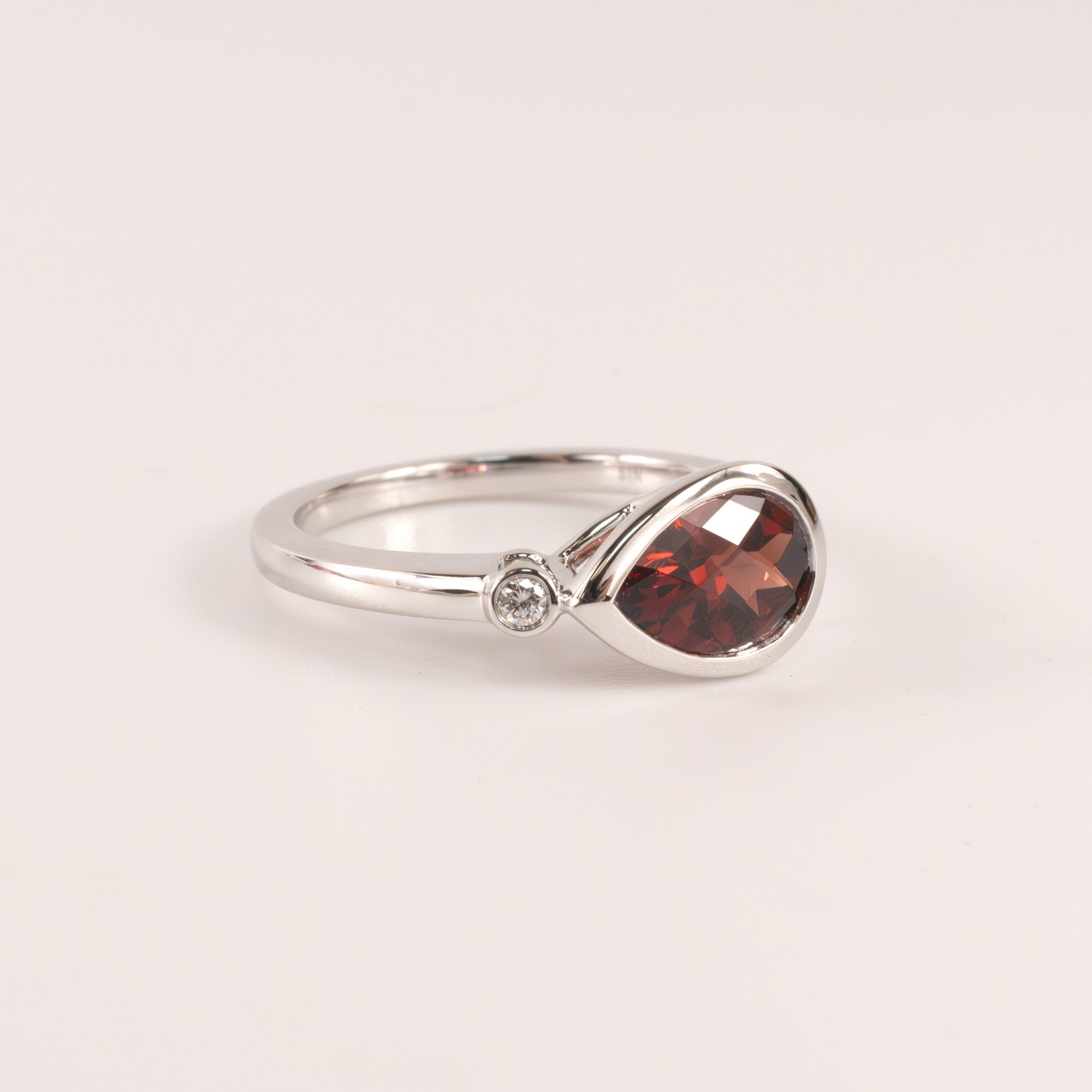14KWG Garnet Pear and Diamond East-West Bezel Set Ring