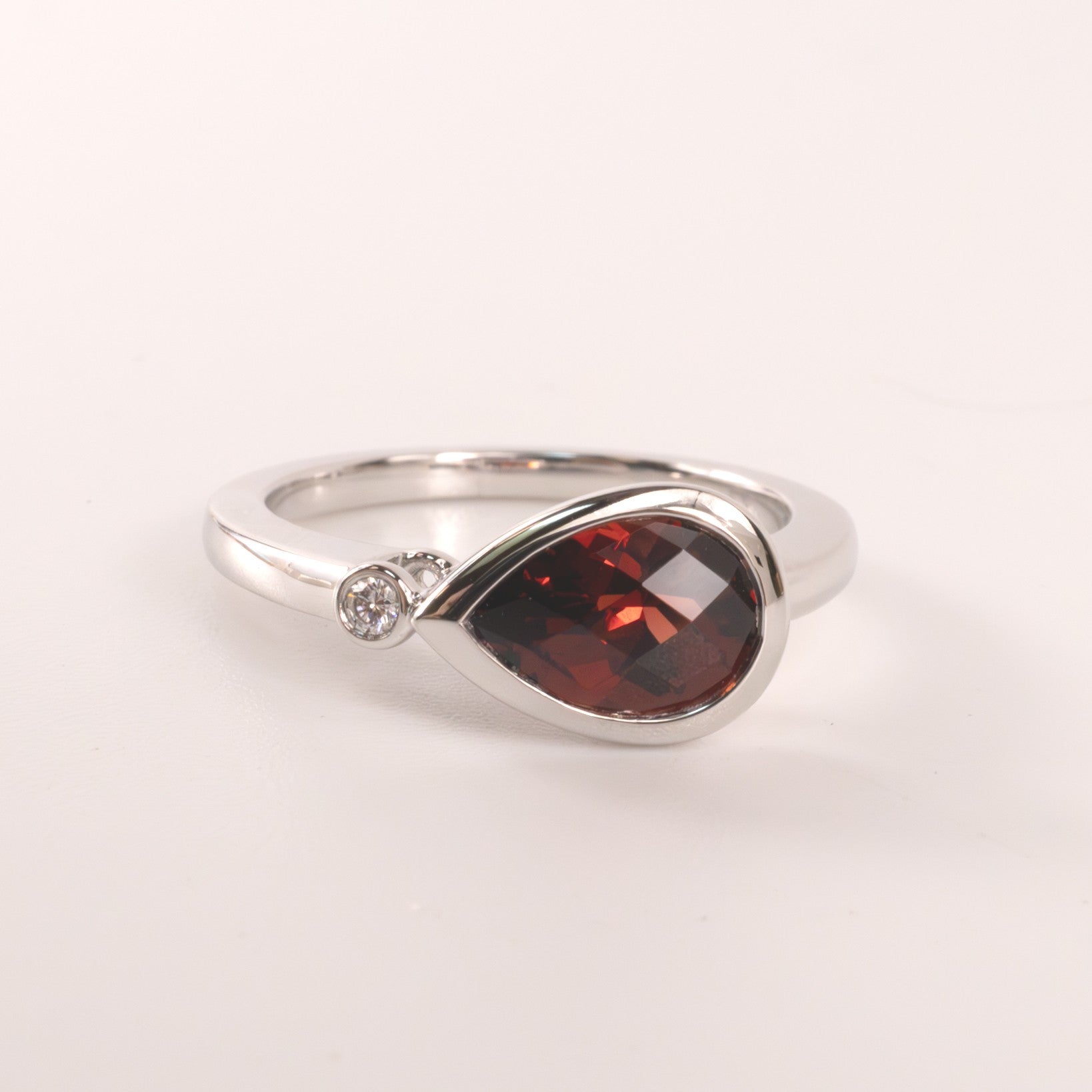 14KWG Garnet Pear and Diamond East-West Bezel Set Ring