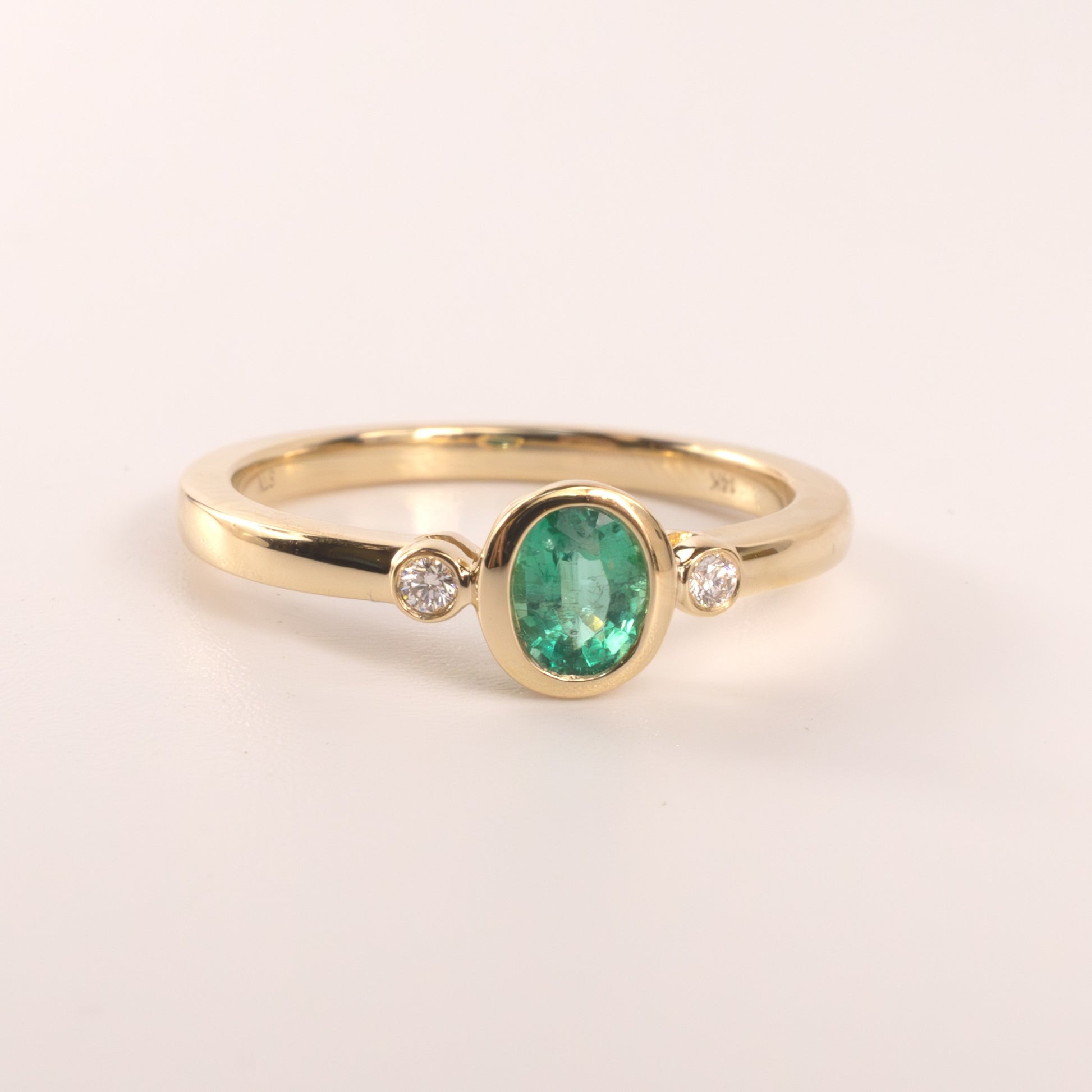 14KYG Emerald Oval and Diamond 3-Stone Bezel Set Ring